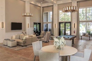 a large living room with a pool table and a flat screen tv on the wall