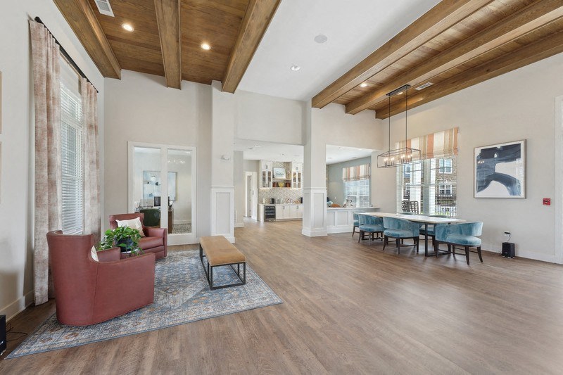 a spacious living room with a dining area and kitchen in the background