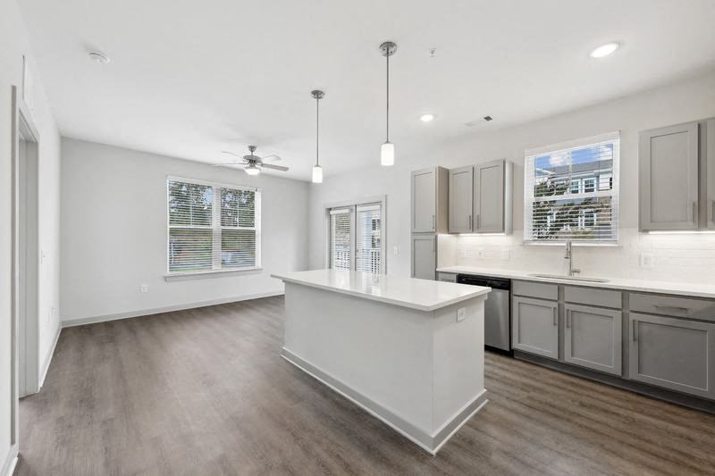 a large kitchen with a center island and a ceiling fan