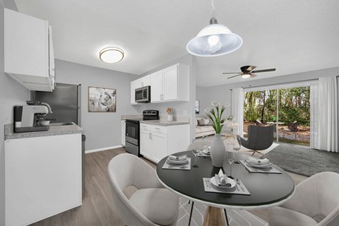 a kitchen and dining room with a table and chairs