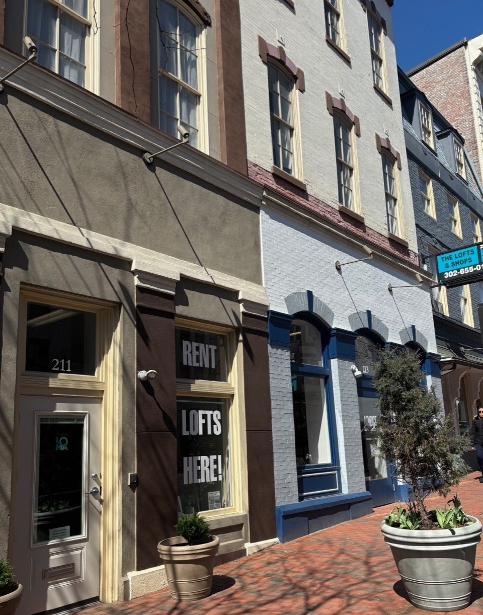 A building with a sign that says "Lofts Here!" is shown.