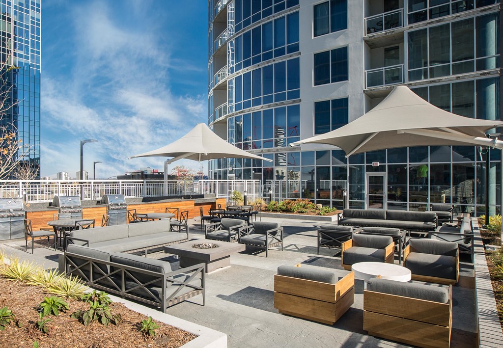 an outdoor patio area with umbrellas and tables in front of a building