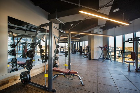 Fitness center with weight training equipment at Placemakr Premier SoBro Apartments, Tennessee