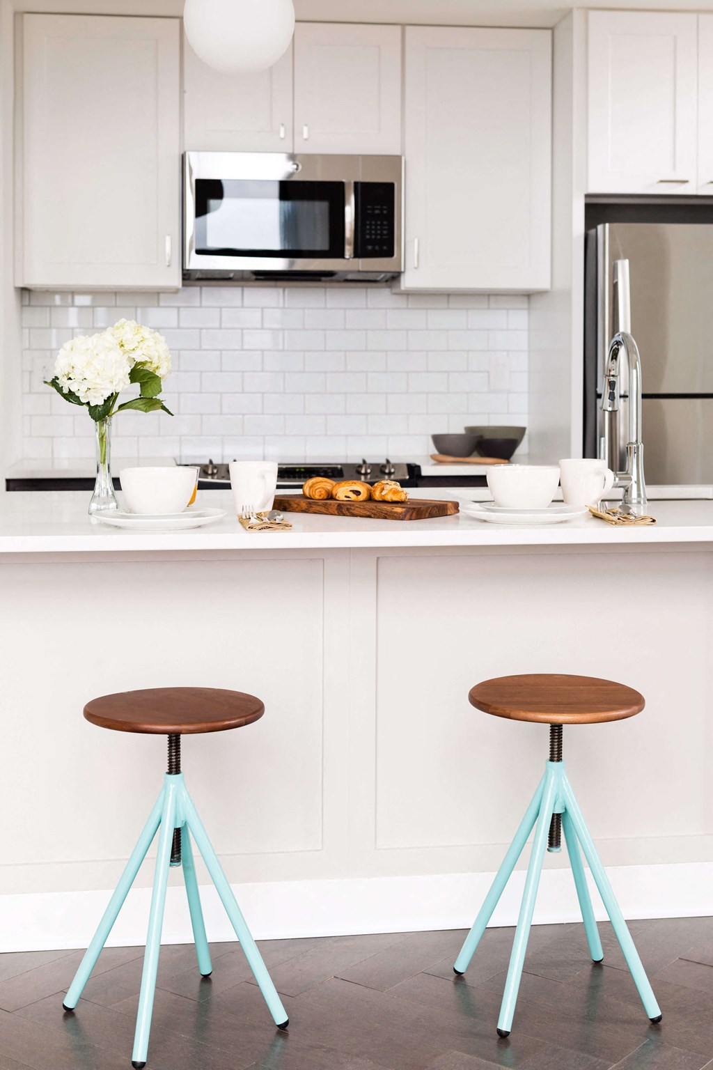 A kitchen with a white tile backsplash and a white fridge at The Pennsylvanian Apartments, Pennsylvania, 15222