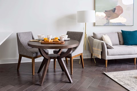 A modern dining room with a round table and chairs at The Pennsylvanian Apartments, Pittsburgh, PA