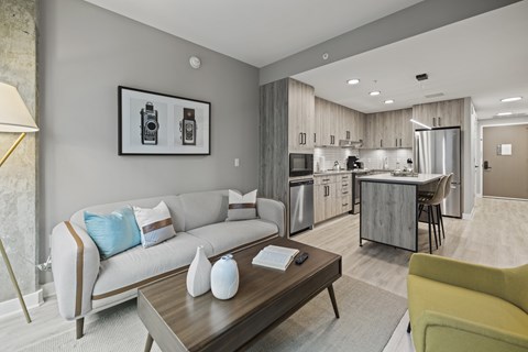 A modern living room with a grey sofa and a coffee table.