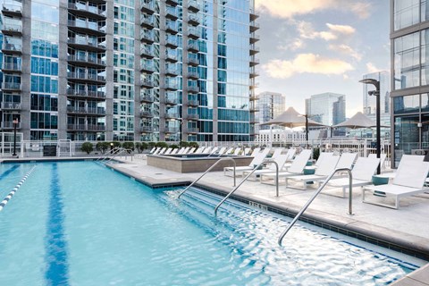 Rooftop pool deck with lounge chairs at Placemakr Premier SoBro Apartments, Nashville, TN