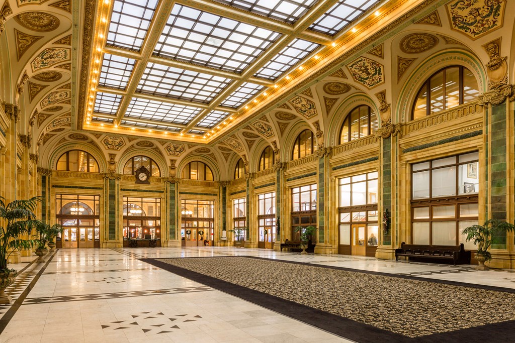 A large, ornate room with a high ceiling and a marble floor at The Pennsylvanian Apartments, Pittsburgh