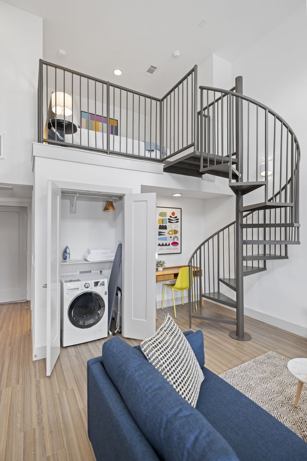 Living Area With Spiral Staircase at Placemakr Downtown Austin, Austin, TX 78701