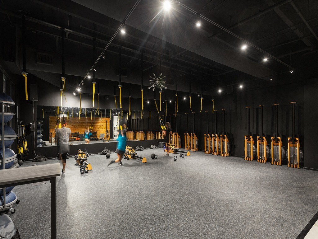 an empty gym with people working out in it