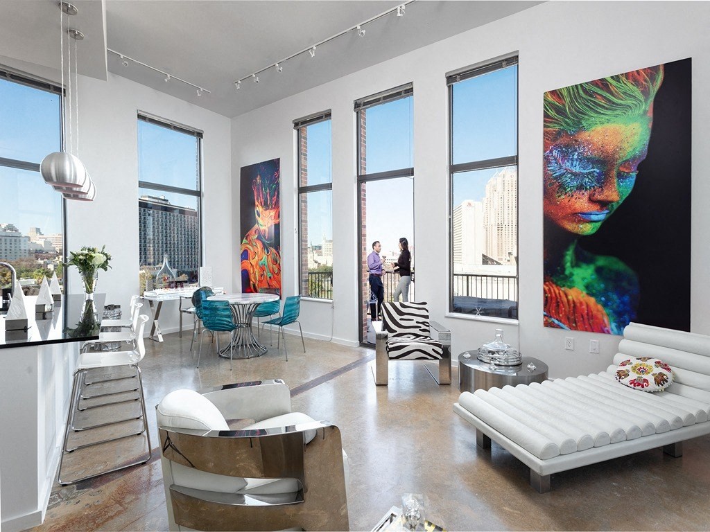 a living room with large windows and a white couch
