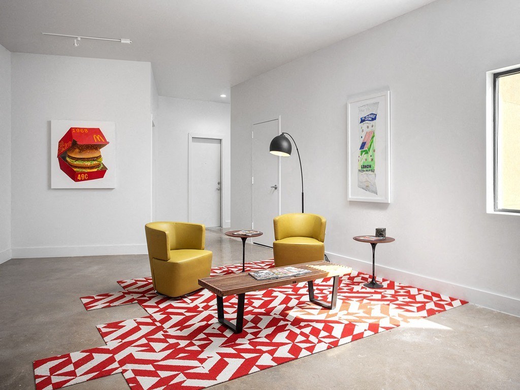 a room with a red and white carpet and a yellow chair