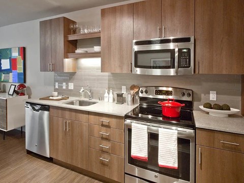 A modern kitchen with a stove top oven and microwave.