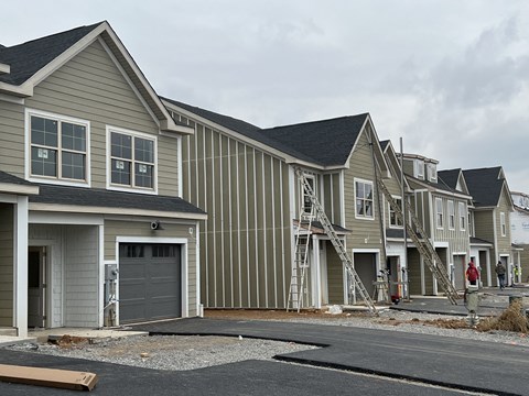 a row of new homes being constructed in a city