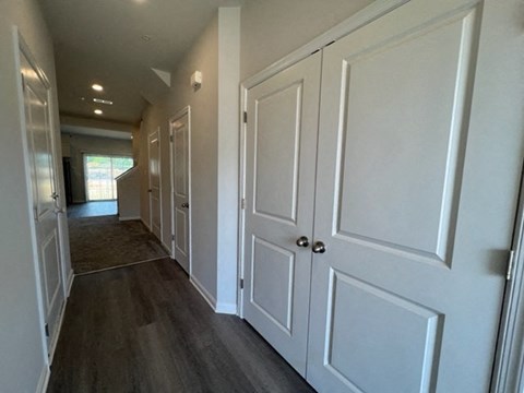 a hallway with white doors and a hall way