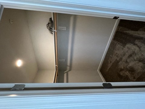 a window with a view of a closet and a door