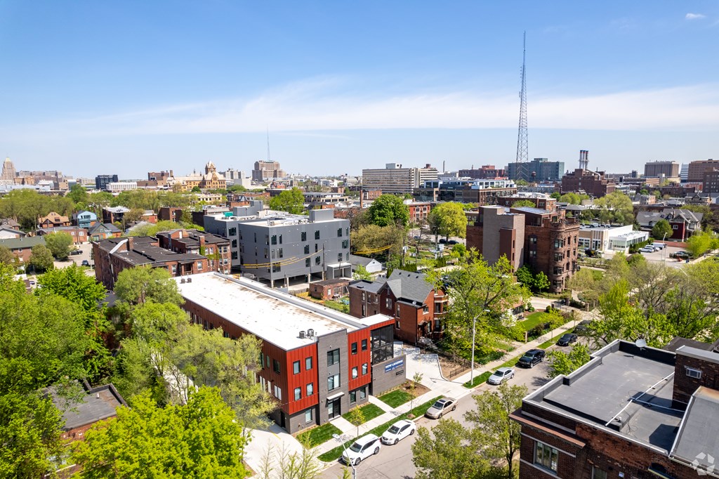 A cityscape with a mix of residential and commercial buildings.
