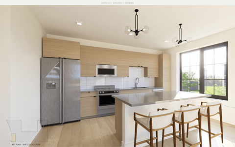 A modern kitchen with a large island and chairs.