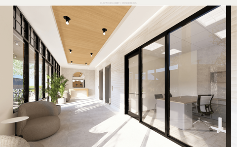 A modern interior space with a wooden ceiling and glass walls.