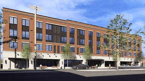A large brick building with a parking lot in front.