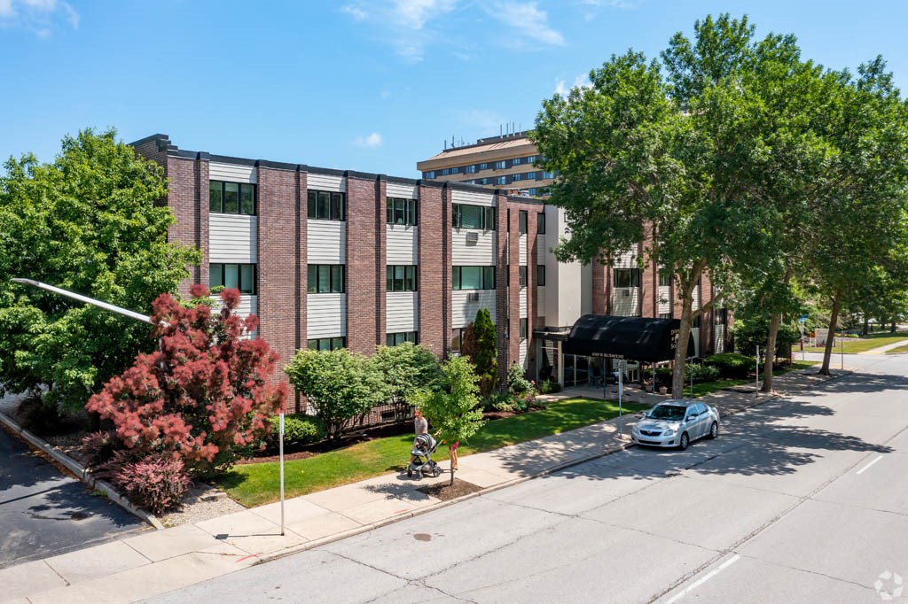 an aerial view of an apartment building with a car parked in front