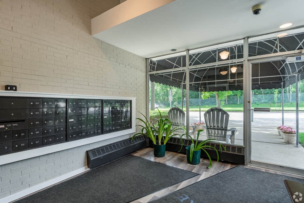 the lobby of a building with patio furniture and a large window