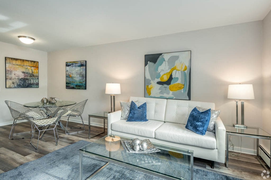 a living room with a couch and a table and chairs