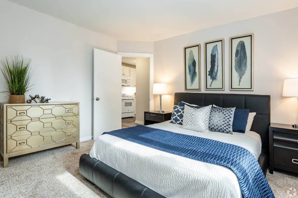 a bedroom with a bed and a dresser