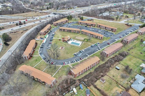 A large building complex with a parking lot in front.