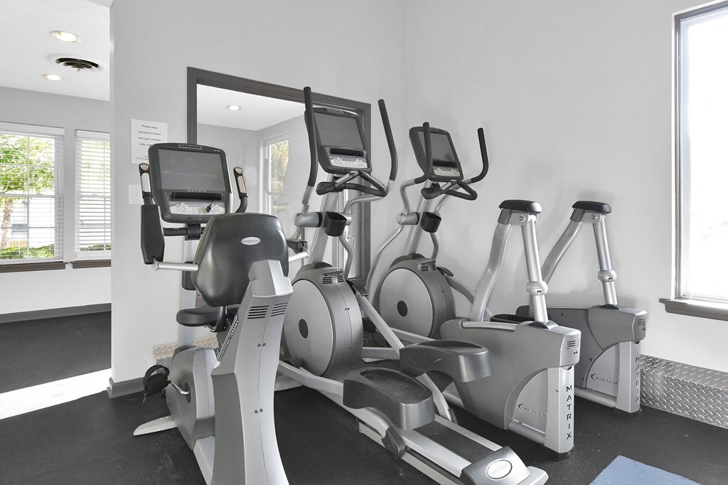 a row of exercise bikes in a gym