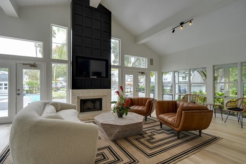 A living room with a fireplace and a television.