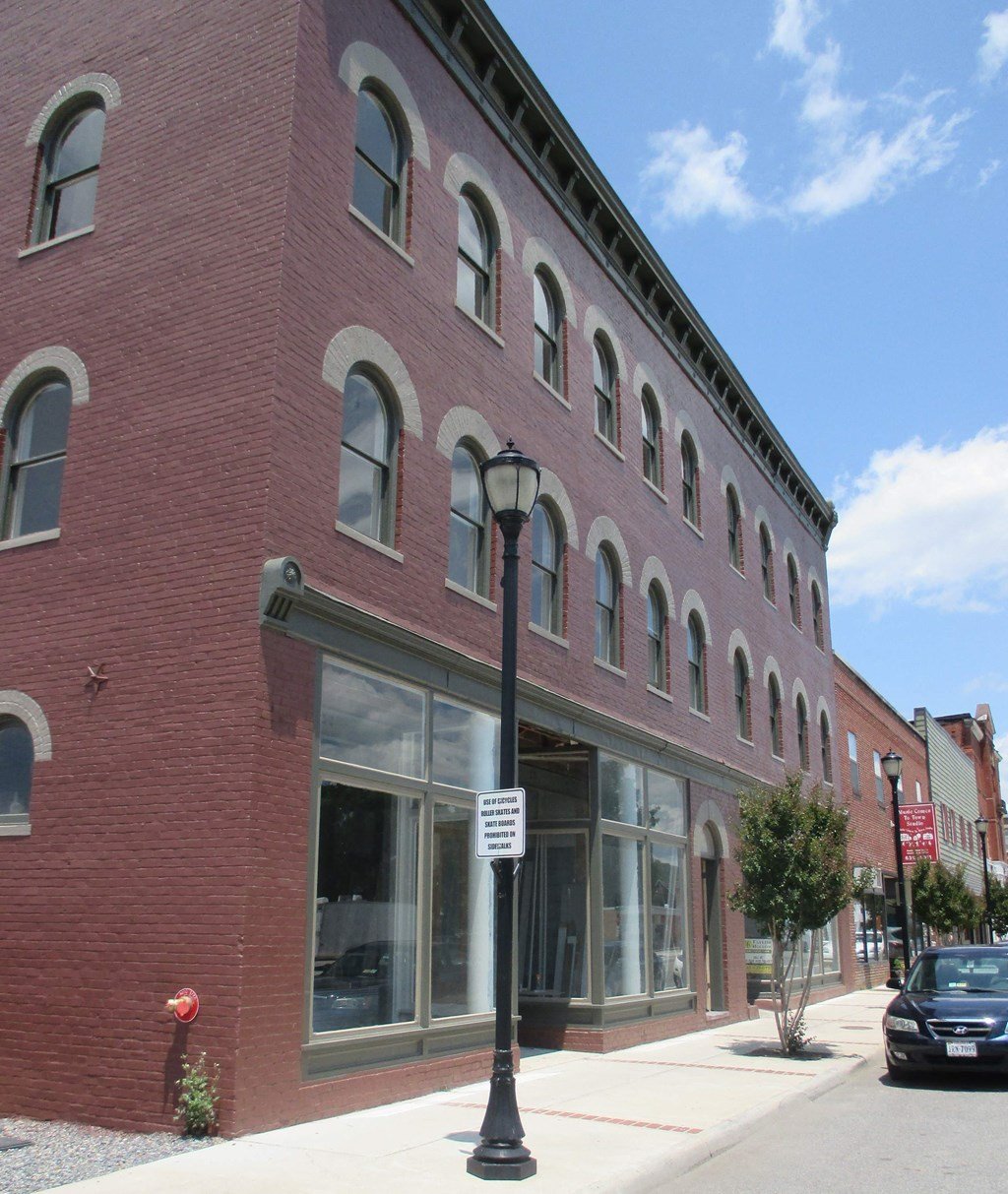 a red brick building with a street light in front of it