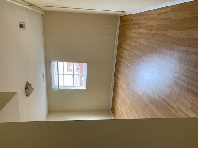 an empty room with a window and a wooden floor
