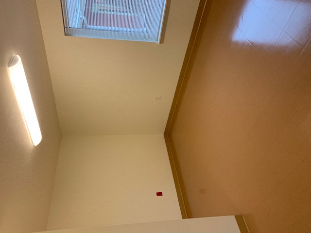 a view of a room with a window and a white table