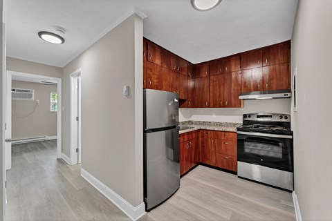 A kitchen with wooden cabinets and stainless steel appliances.