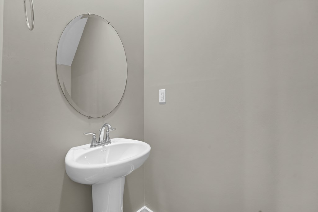 a small bathroom with a sink and a mirror