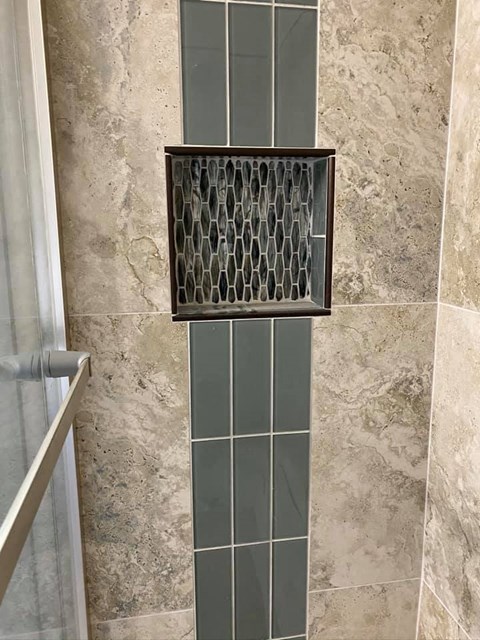 a bathroom with a shower with a glass door