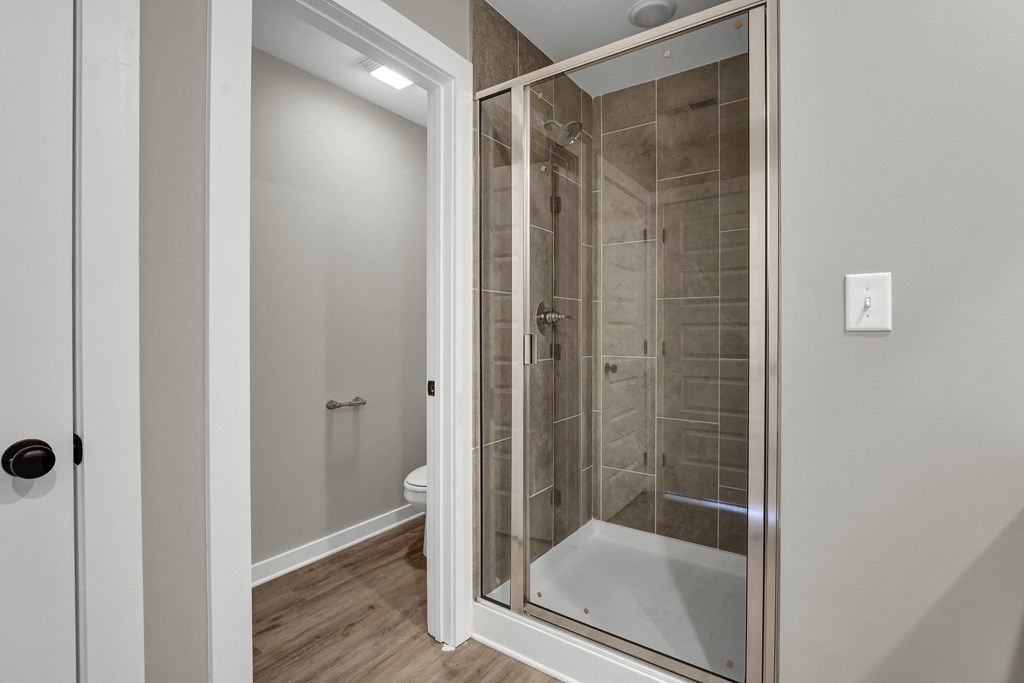 a bathroom with a shower and a toilet in it