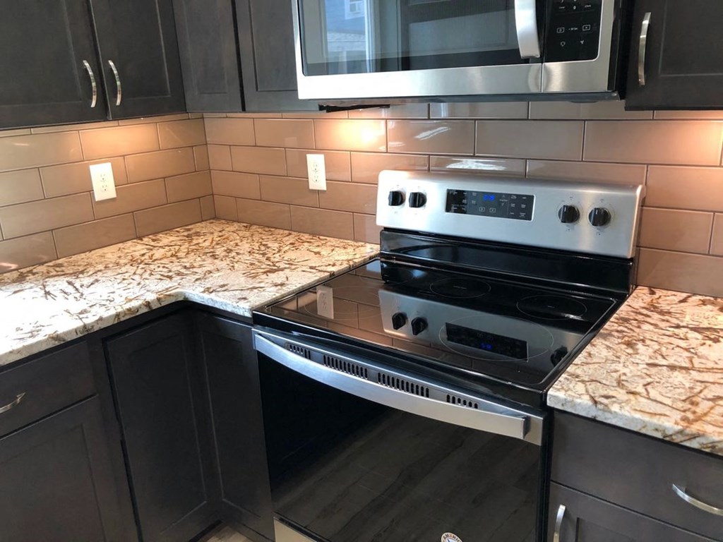 a kitchen with a stove and counter tops