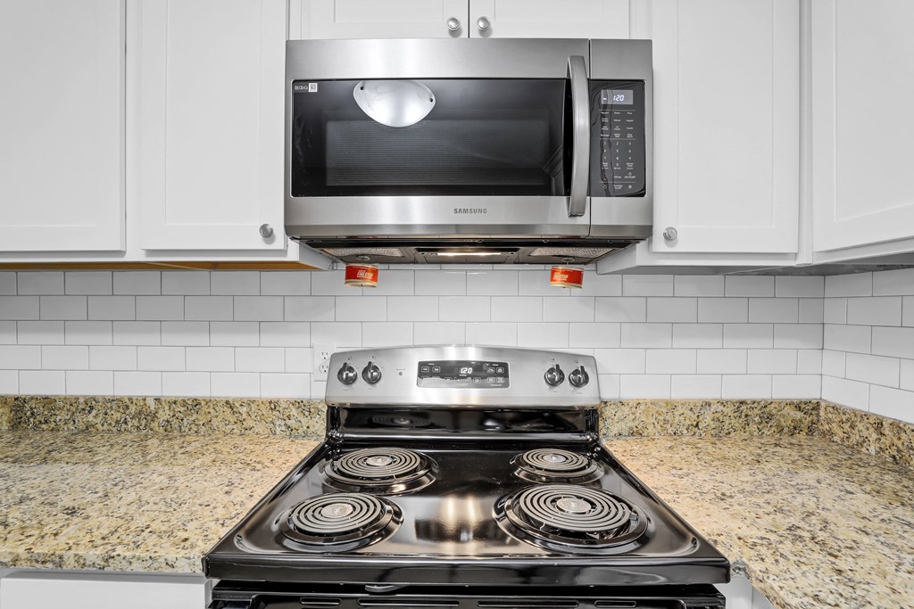 a kitchen with a stove and a microwave