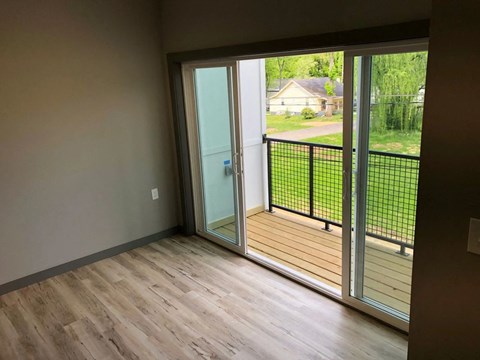 a living room with sliding glass doors to a balcony