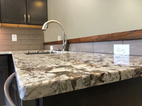 a kitchen counter with a marble counter top