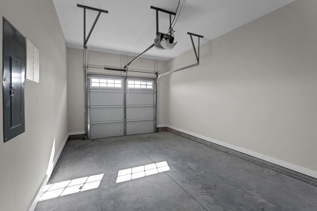 an empty garage with a white wall and a garage door