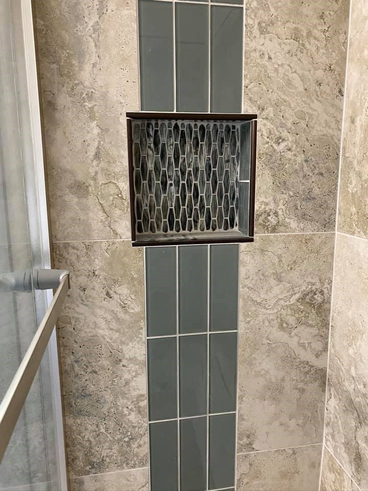 a bathroom with a shower with a glass door