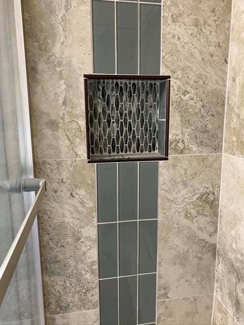 a bathroom with a shower with a glass door