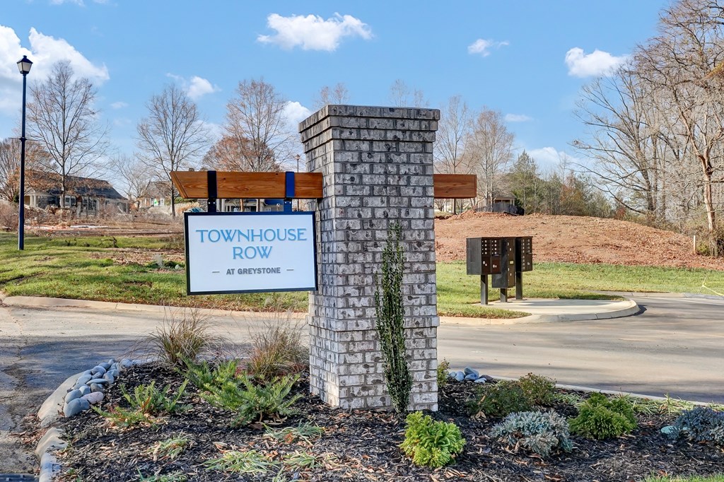a townhouse row sign in front of a road