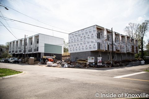 a building under construction on the corner of a street