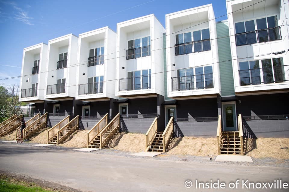 a large white building with stairs in front of it