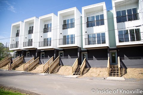 a large white building with stairs in front of it