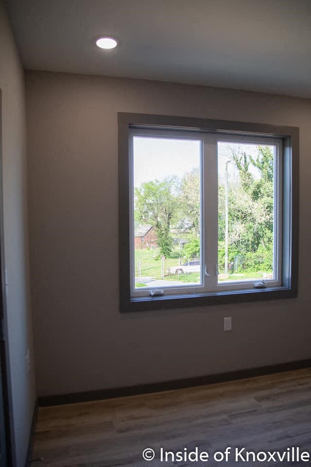 a large window in a room with a wooden floor